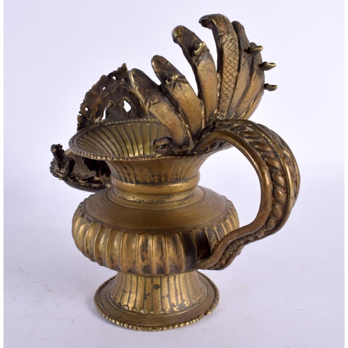 739 - AN UNUSUAL 18TH/19TH CENTURY INDIAN BRONZE HOLY OIL VESSEL formed with Ganesha behind a flaming term... 