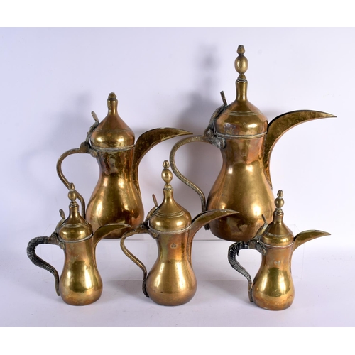 748 - A RARE SET OF FIVE 19TH CENTURY MIDDLE EASTERN OMANI TYPE BRONZE EWERS with large spouts. Largest 42... 