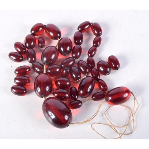 1008 - ASSORTED CHERRY AMBER TYPE BEADS. 51.5 grams. Largest bead 2.25 cm x 1.5 cm. (qty)