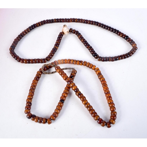 1055 - TWO MIDDLE EASTERN AMBER TYPE PRAYER BEAD NECKLACES. 198 grams. Longest 86 cm. (2)