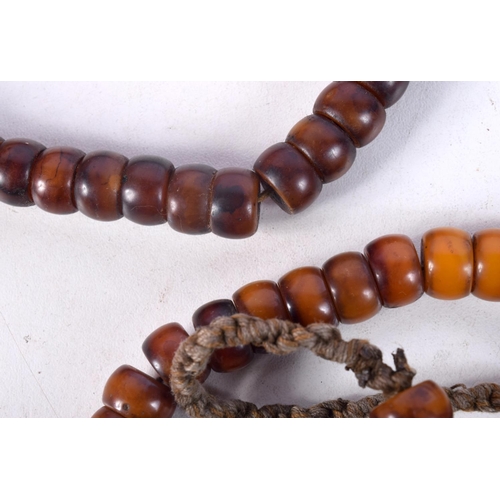 1055 - TWO MIDDLE EASTERN AMBER TYPE PRAYER BEAD NECKLACES. 198 grams. Longest 86 cm. (2)