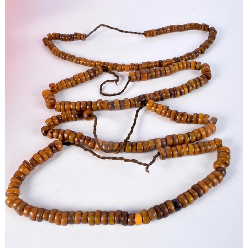 1056 - FOUR MIDDLE EASTERN AMBER TYPE PRAYER BEAD NECKLACES. 589 grams. Longest 80 cm. (4)