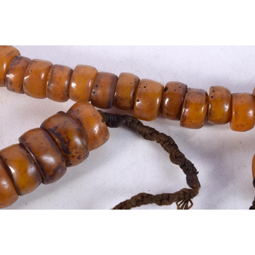 1056 - FOUR MIDDLE EASTERN AMBER TYPE PRAYER BEAD NECKLACES. 589 grams. Longest 80 cm. (4)