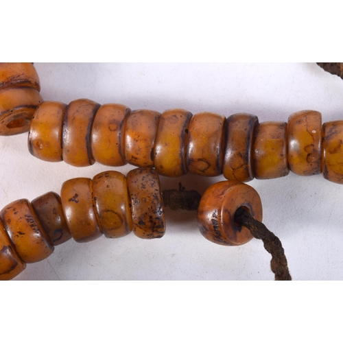 1056 - FOUR MIDDLE EASTERN AMBER TYPE PRAYER BEAD NECKLACES. 589 grams. Longest 80 cm. (4)