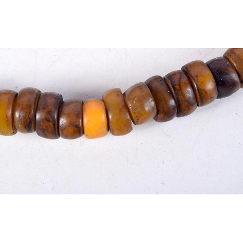 1056 - FOUR MIDDLE EASTERN AMBER TYPE PRAYER BEAD NECKLACES. 589 grams. Longest 80 cm. (4)