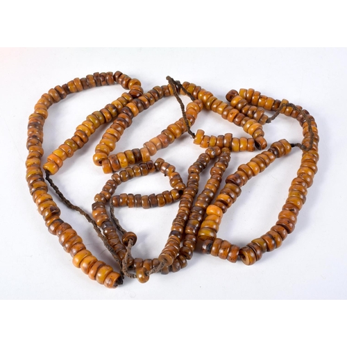 1057 - FOUR MIDDLE EASTERN AMBER TYPE PRAYER BEAD NECKLACES. 600 grams. Longest 86 cm. (4)