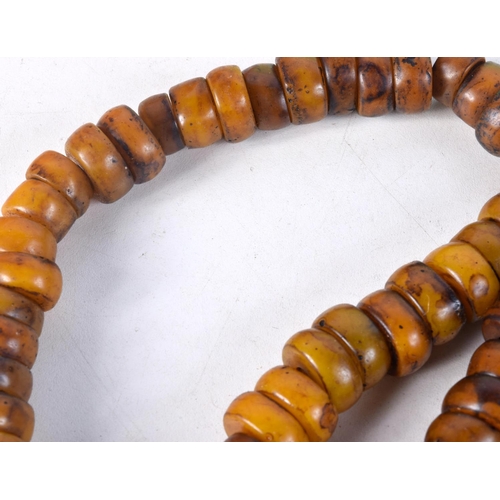 1057 - FOUR MIDDLE EASTERN AMBER TYPE PRAYER BEAD NECKLACES. 600 grams. Longest 86 cm. (4)