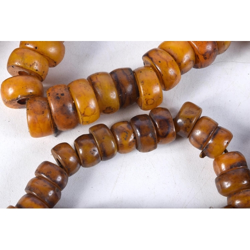 1057 - FOUR MIDDLE EASTERN AMBER TYPE PRAYER BEAD NECKLACES. 600 grams. Longest 86 cm. (4)