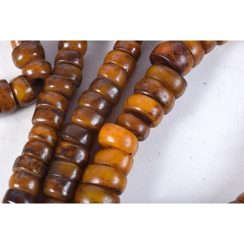 1057 - FOUR MIDDLE EASTERN AMBER TYPE PRAYER BEAD NECKLACES. 600 grams. Longest 86 cm. (4)