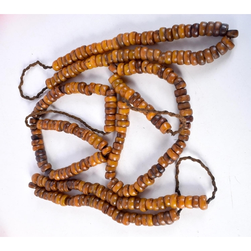 1058 - FOUR MIDDLE EASTERN AMBER TYPE PRAYER BEAD NECKLACES. 626 grams. Longest 86 cm. (4)