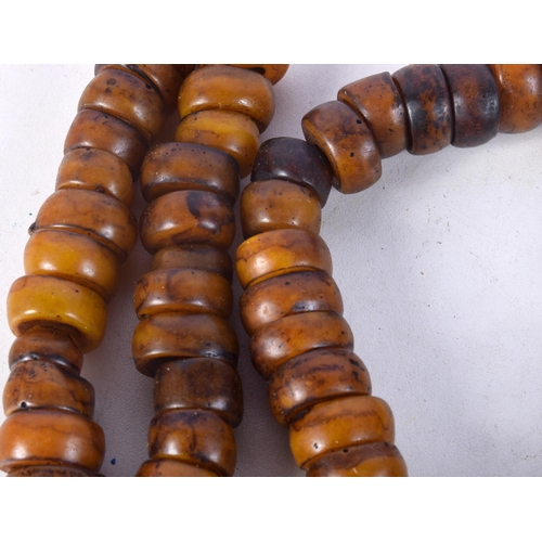 1058 - FOUR MIDDLE EASTERN AMBER TYPE PRAYER BEAD NECKLACES. 626 grams. Longest 86 cm. (4)