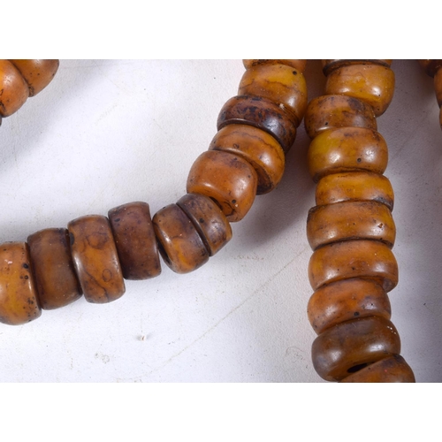 1058 - FOUR MIDDLE EASTERN AMBER TYPE PRAYER BEAD NECKLACES. 626 grams. Longest 86 cm. (4)