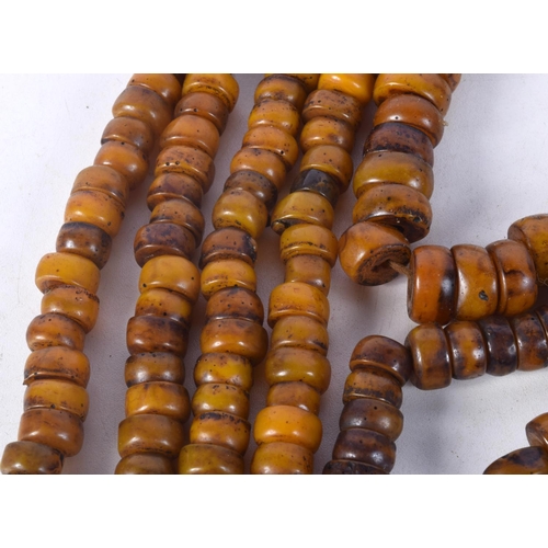 1059 - FOUR MIDDLE EASTERN AMBER TYPE PRAYER BEAD NECKLACES. 512 grams. Longest 92 cm. (4)