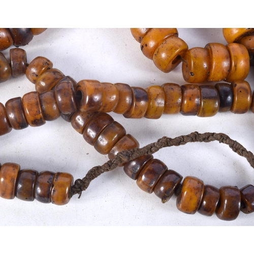 1059 - FOUR MIDDLE EASTERN AMBER TYPE PRAYER BEAD NECKLACES. 512 grams. Longest 92 cm. (4)