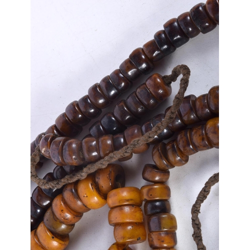 1059 - FOUR MIDDLE EASTERN AMBER TYPE PRAYER BEAD NECKLACES. 512 grams. Longest 92 cm. (4)