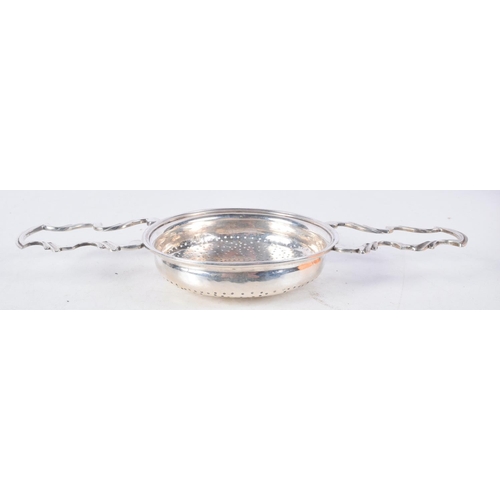 1102 - A GEORGE III TWIN HANDLED SILVER TEA STRAINER. London 1816. 95 grams. 23.5 cm x 10 cm.