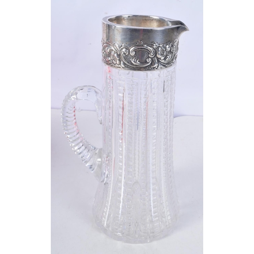 1117 - A STERLING SILVER AND CUT GLASS JUG. 26 cm x 12 cm.