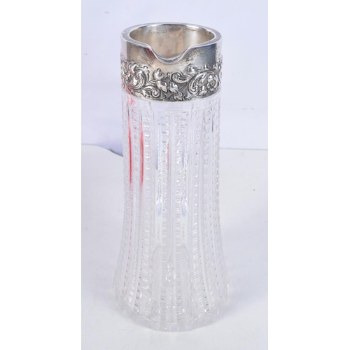 1117 - A STERLING SILVER AND CUT GLASS JUG. 26 cm x 12 cm.