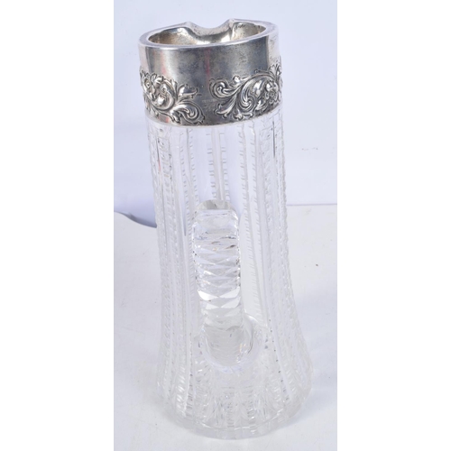 1117 - A STERLING SILVER AND CUT GLASS JUG. 26 cm x 12 cm.