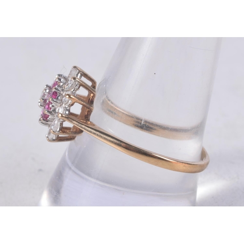 1142 - A 9CT GOLD DIAMOND AND RUBY CLUSTER RING. 2.4 grams. S.