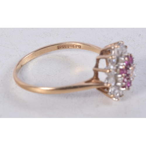 1142 - A 9CT GOLD DIAMOND AND RUBY CLUSTER RING. 2.4 grams. S.