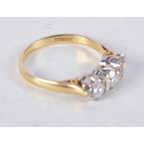 1146 - A GOOD 18CT GOLD AND DIAMOND THREE STONE RING. 3.4 grams. N.