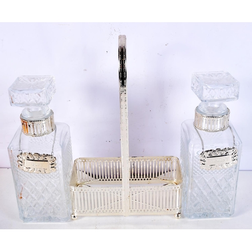 1191 - A SILVER PLATED CUT GLASS TWIN DECANTER SET with labels. 32 cm x 15 cm.