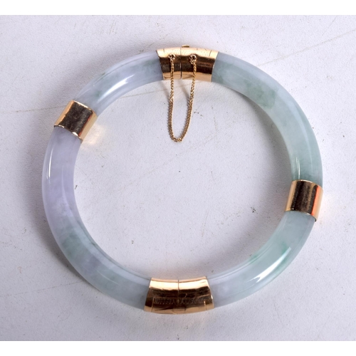 1274 - A CHINESE GOLD AND JADE BANGLE. 6 cm diameter.