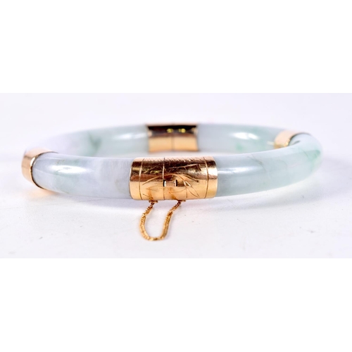 1274 - A CHINESE GOLD AND JADE BANGLE. 6 cm diameter.