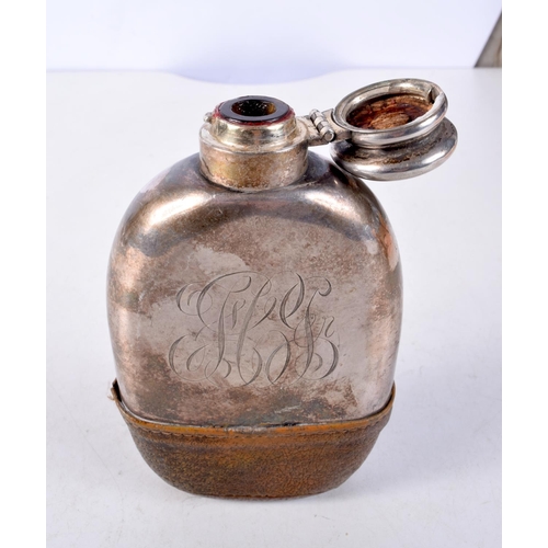 1306 - AN ANTIQUE WHITE METAL AND LEATHER HIP FLASK. 290 grams. 8.5 cm x 14.5 cm.