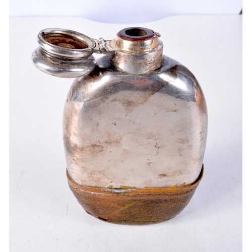 1306 - AN ANTIQUE WHITE METAL AND LEATHER HIP FLASK. 290 grams. 8.5 cm x 14.5 cm.