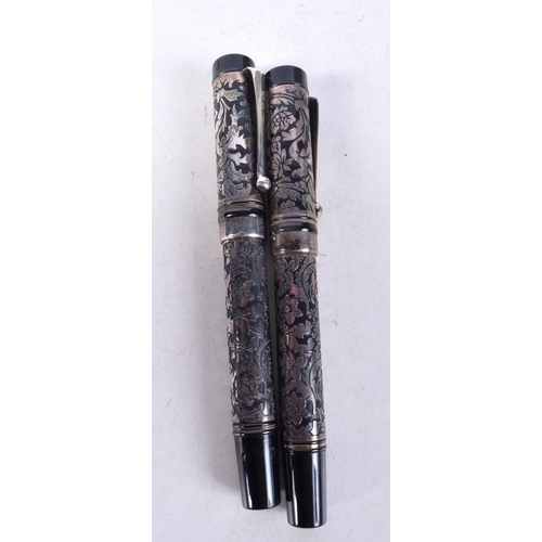 1323 - A PAIR OF SILVER OVERLAID PENS. 85 grams. 13 cm x 2 cm.