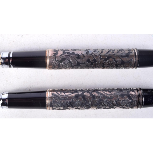 1323 - A PAIR OF SILVER OVERLAID PENS. 85 grams. 13 cm x 2 cm.