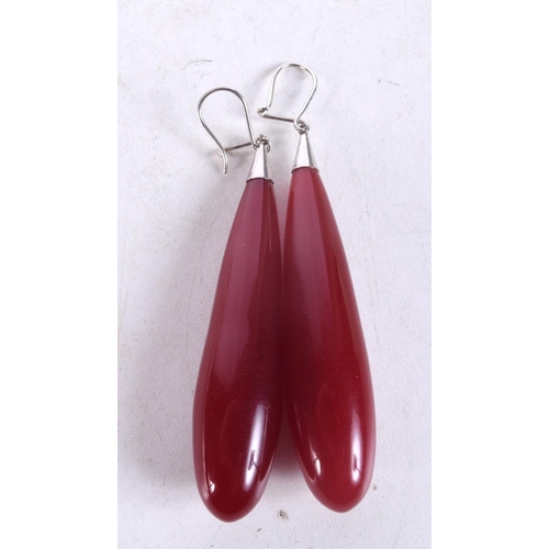 1325 - A PAIR OF VINTAGE CHERRY AMBER TYPE EARRINGS. 9.5 cm long.