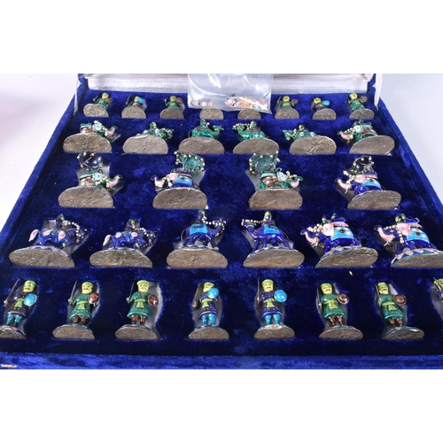 1433E - A RARE INDIAN SILVER AND ENAMEL CHESS SET modelled in various forms and sizes. 1266 grams. Largest 8... 