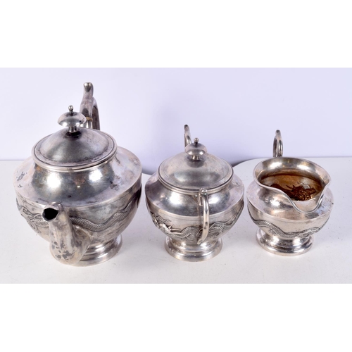 1438J - A 19TH CENTURY CHINESE EXPORT THREE PIECE SILVER AND IVORY TEASET decorated with dragons. 1168 grams... 