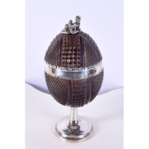 1474 - A RARE 18TH CENTURY SWEDISH SILVER MOUNTED COCONUT CUP AND COVER with figural terminal. 171 grams. 1... 