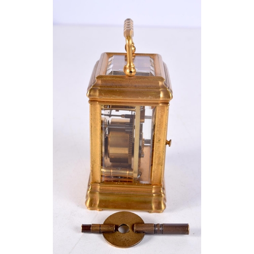 1483 - A MINIATURE BRASS CARRIAGE CLOCK. 9 cm high inc handle.