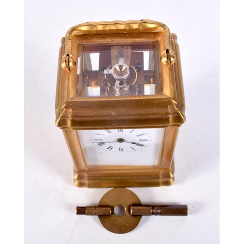 1483 - A MINIATURE BRASS CARRIAGE CLOCK. 9 cm high inc handle.