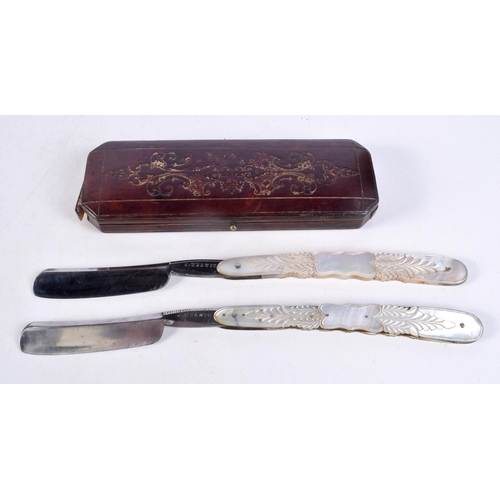 1487 - A PAIR OF ANTIQUE MOTHER OF PEARL RAZORS. 24.5 cm long extended.