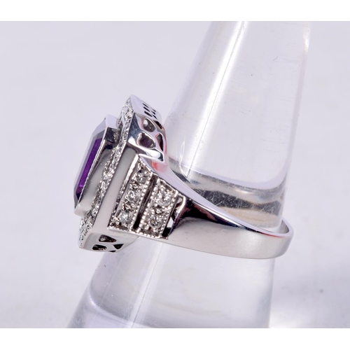 753 - AN 18CT WHITE GOLD, DIAMOND AND AMETHYST RING.  Stamped 18K, Size O, weight 9.6g