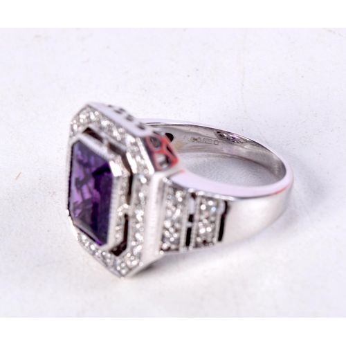 753 - AN 18CT WHITE GOLD, DIAMOND AND AMETHYST RING.  Stamped 18K, Size O, weight 9.6g