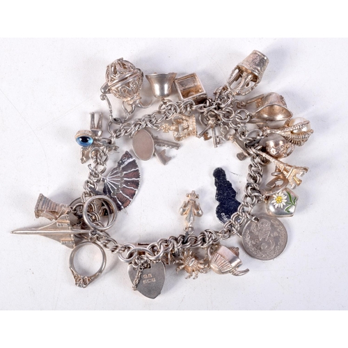 768 - A SILVER CHARM BRACELET.  Clasp Hallmarked Birmingham 1992, 5.6cm internal diameter, weight 51.8g