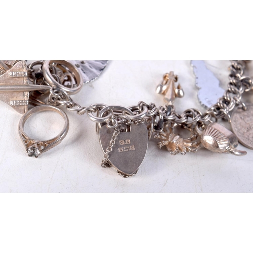 768 - A SILVER CHARM BRACELET.  Clasp Hallmarked Birmingham 1992, 5.6cm internal diameter, weight 51.8g