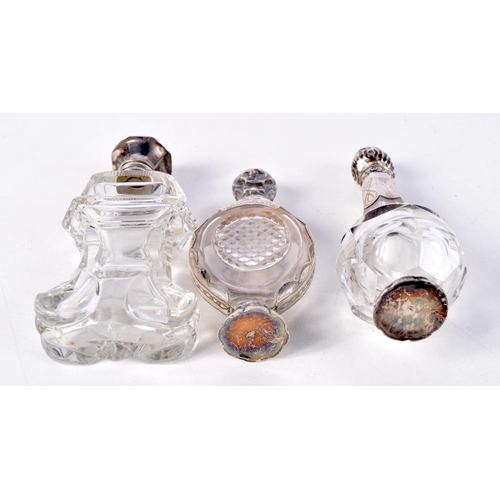 797 - THREE SILVER MOUNTED SCENT BOTTLES.  Largest 11.5cm x 3.5cm (3)