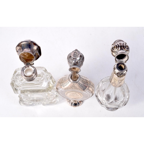 797 - THREE SILVER MOUNTED SCENT BOTTLES.  Largest 11.5cm x 3.5cm (3)