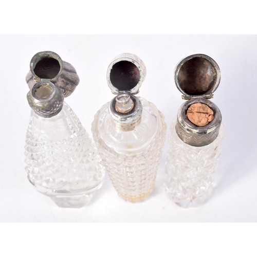 811 - THREE SILVER MOUNTED SCENT BOTTLES.  Largest 10.7cm x 3.6cm x 2.3cm (3)