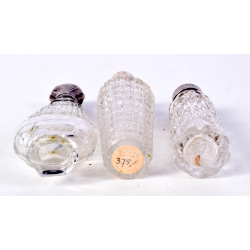 811 - THREE SILVER MOUNTED SCENT BOTTLES.  Largest 10.7cm x 3.6cm x 2.3cm (3)