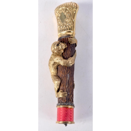 813 - A GILT METAL CAN HANDLE DECORATED WITH A MONKEY CLIMBING A TREE AND AN ENAMEL COLLAR.  Stamped 88, 1... 