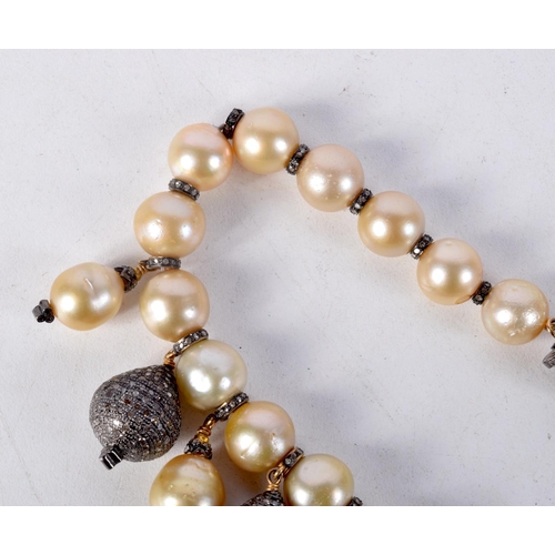 828 - A DIAMOND AND PEARL NECKLACE.  40cm long, largest pearl 12mm, weight 140g